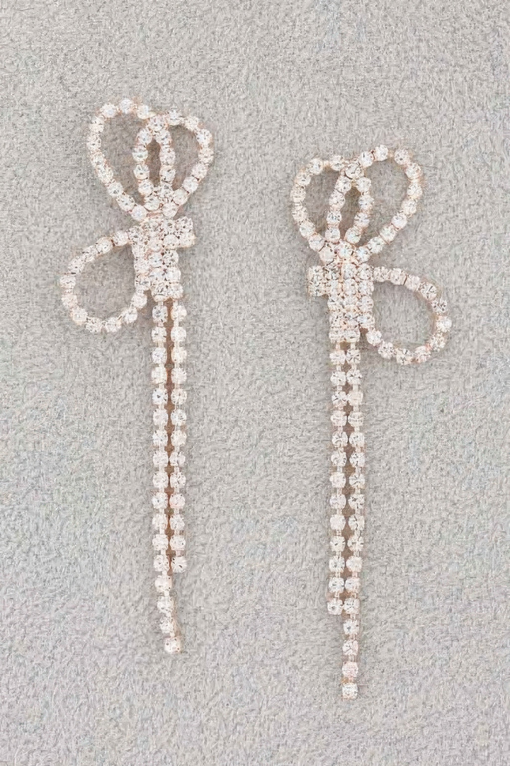 Rhinestone ribbon earrings with bow and long dangling strands, silver-tone