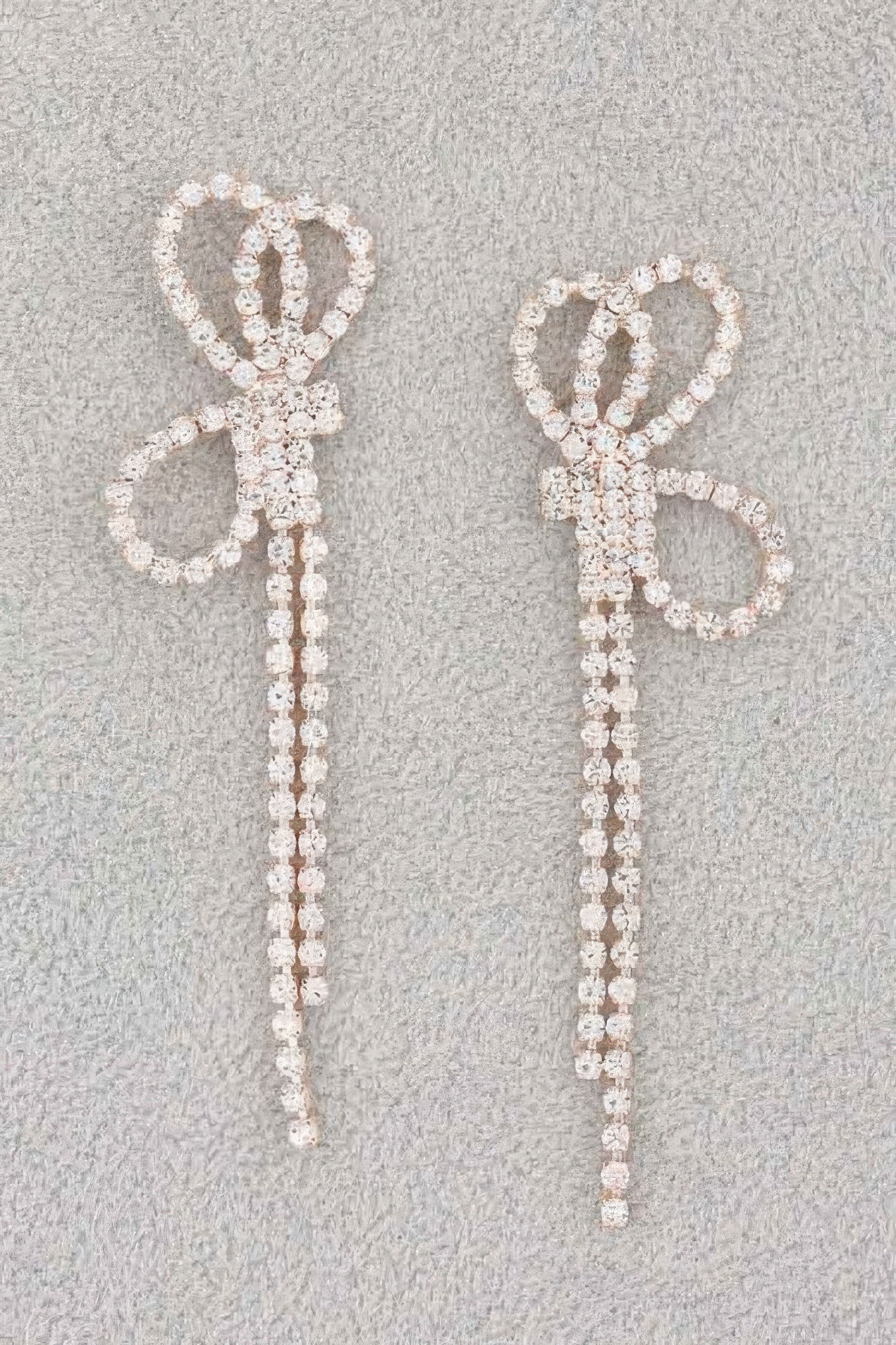 Rhinestone ribbon earrings with bow and long dangling strands, silver-tone