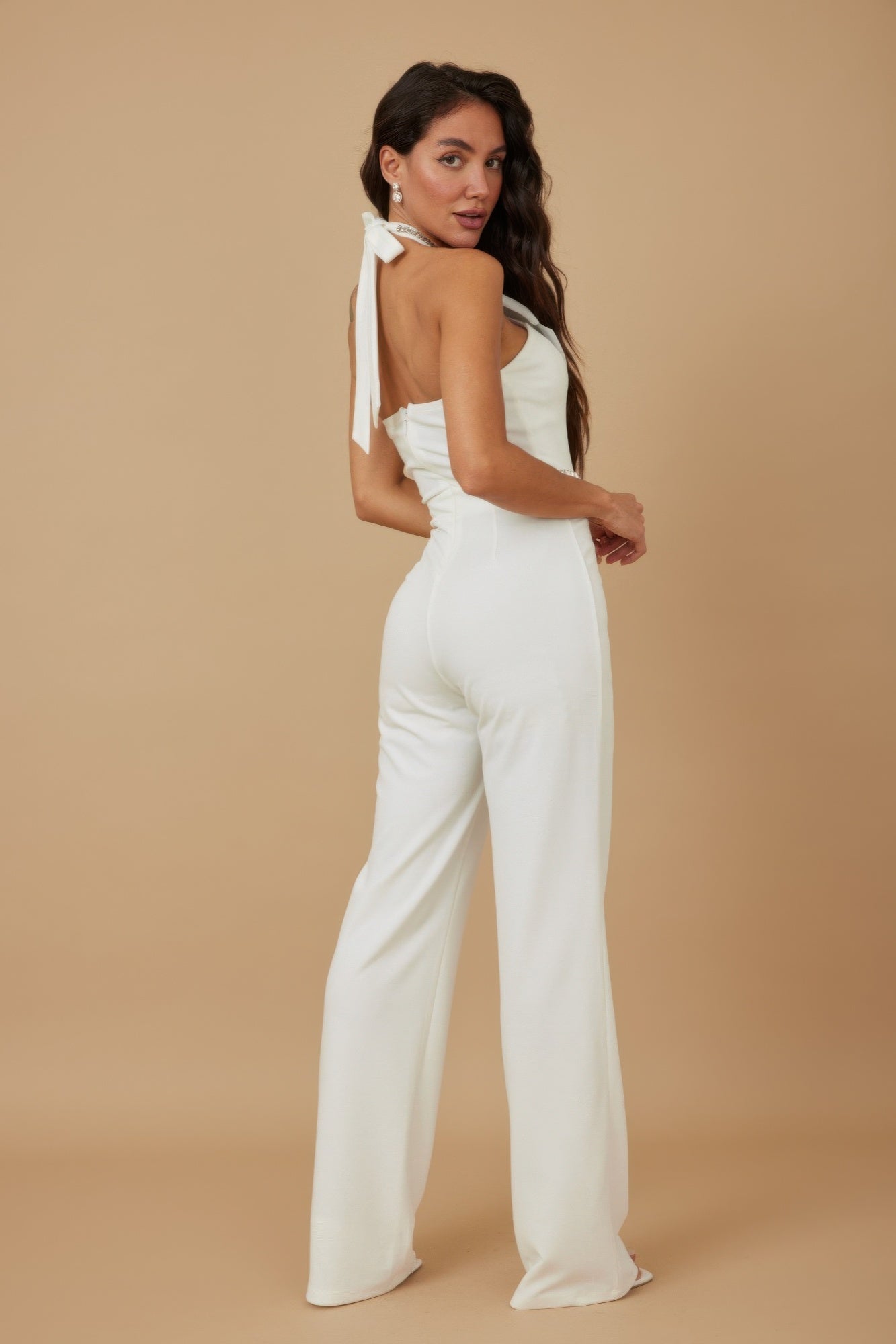 White halter jumpsuit side view with tied ribbon detail at the back
