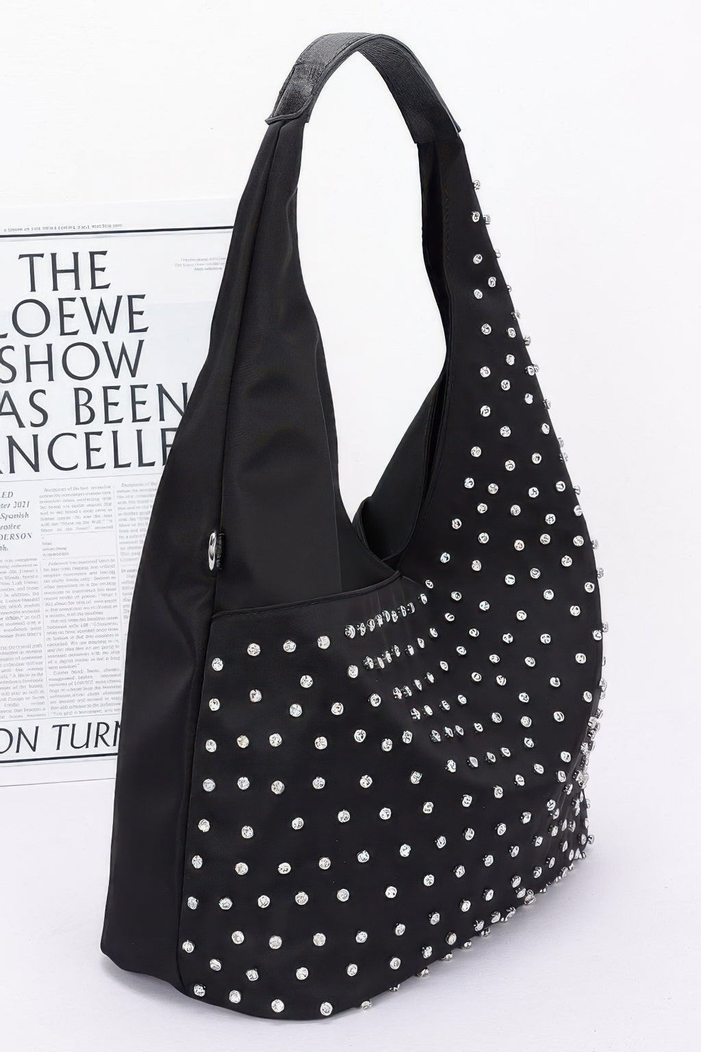Rhinestone-studded black hobo bindle bag with silver studs, side view and strap loops