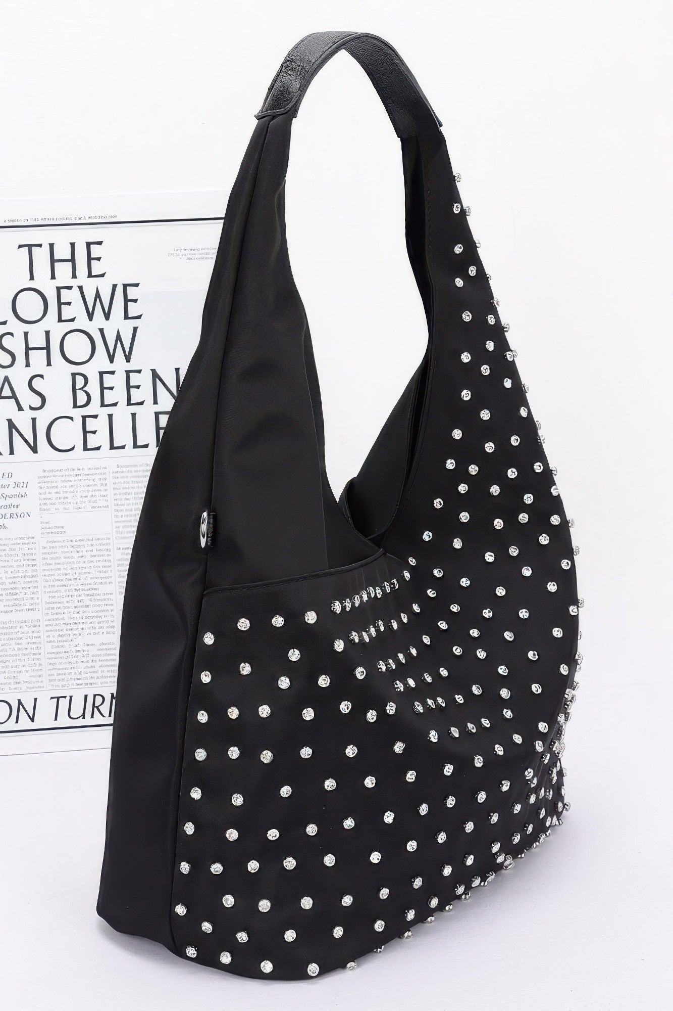 Rhinestone-studded black hobo bindle bag with silver studs, side view and strap loops
