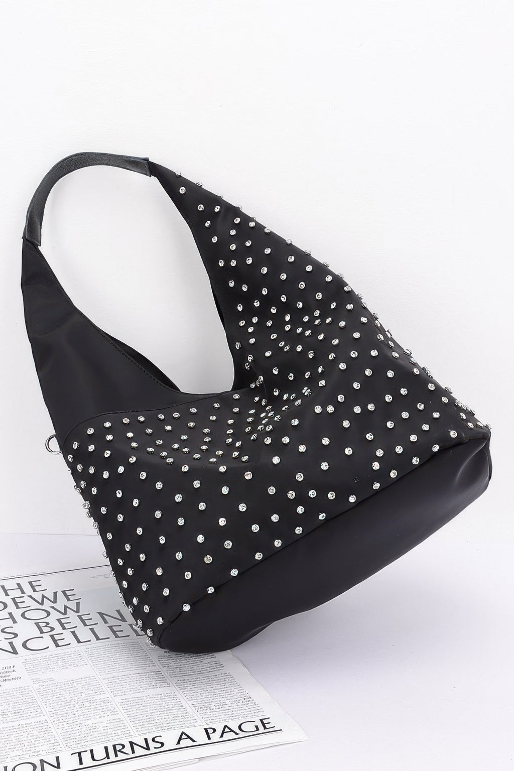 Black rhinestone-studded bindle bag with wide handle and silver studs across the front