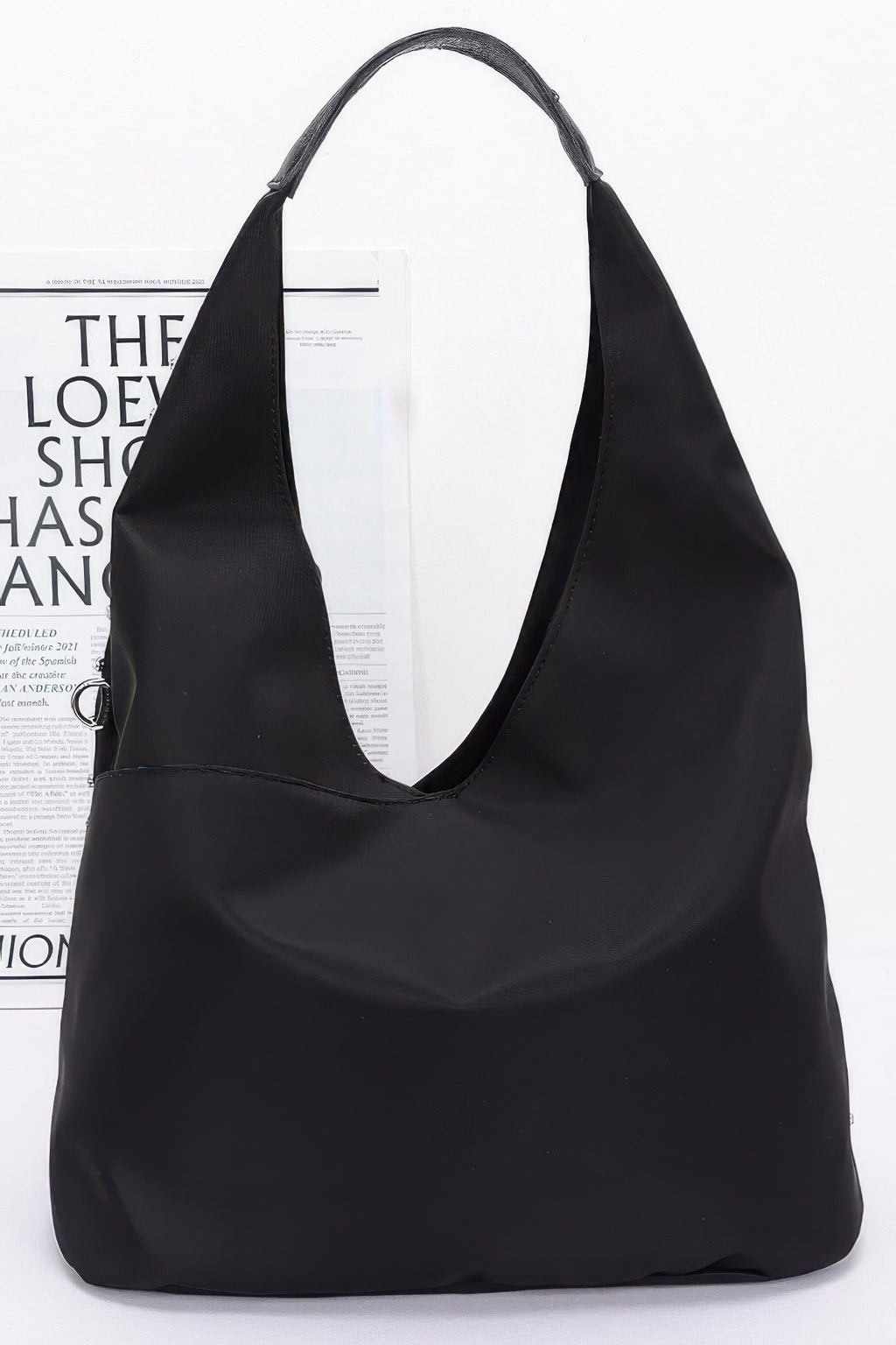 Sleek black hobo-style bag with wide handles, smooth finish, no rhinestone studs visible
