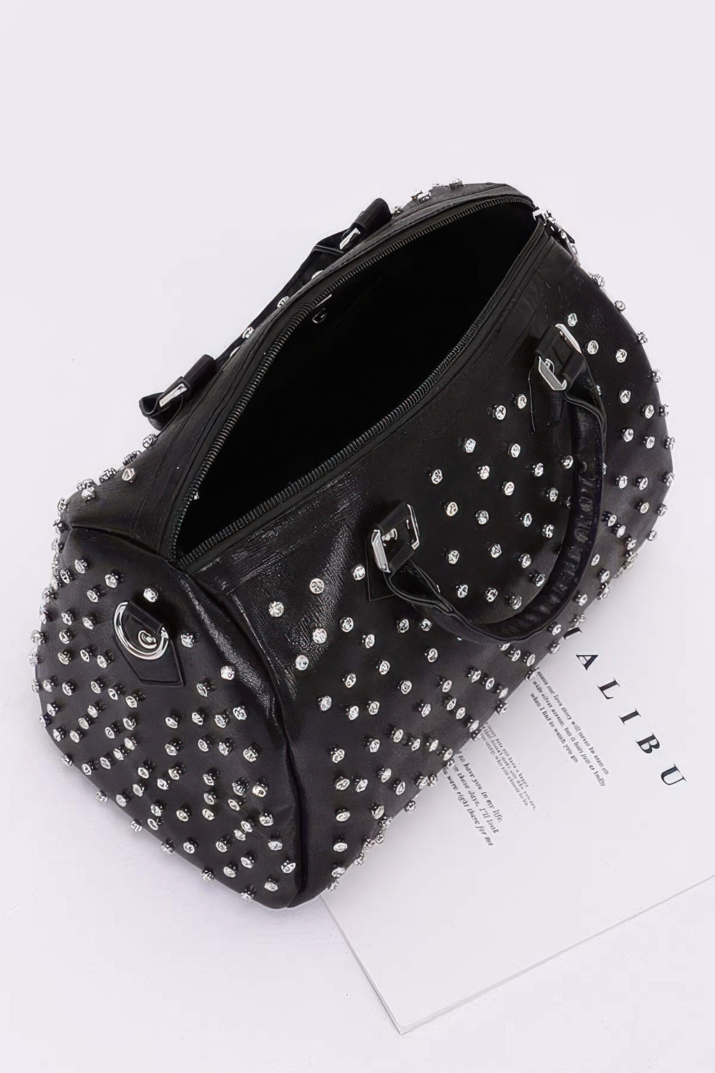 Black rhinestone bowling bag with silver studs, zip top opening, and interior view