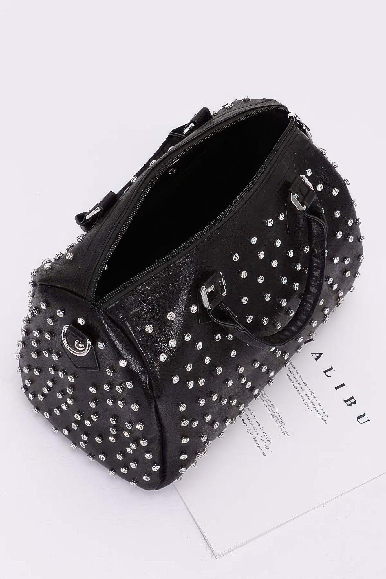 Black rhinestone bowling bag with silver studs, zip top opening, and interior view