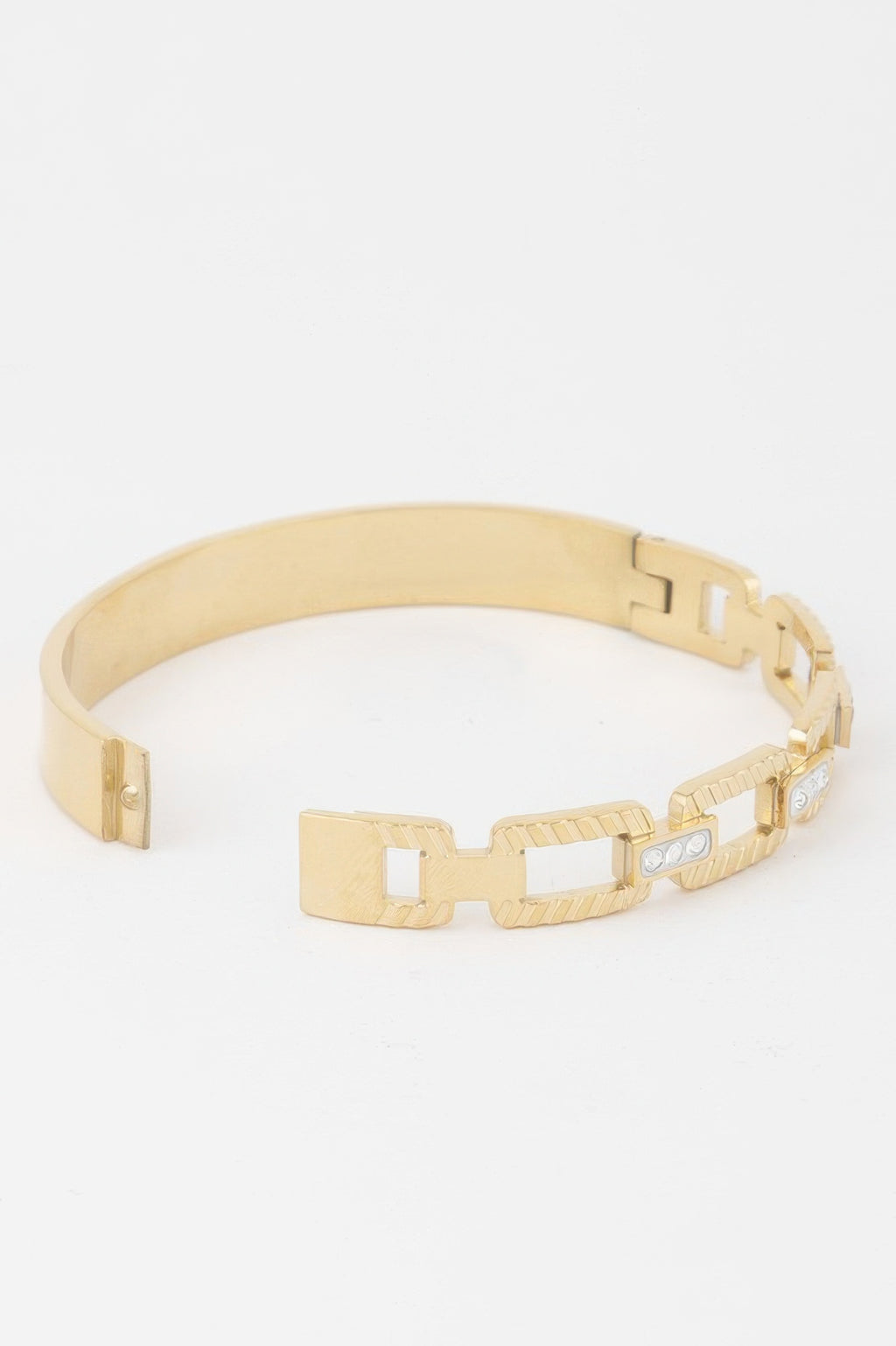 Gold chain clasp bracelet with ribbed links and hinged clasp end, clear inlays