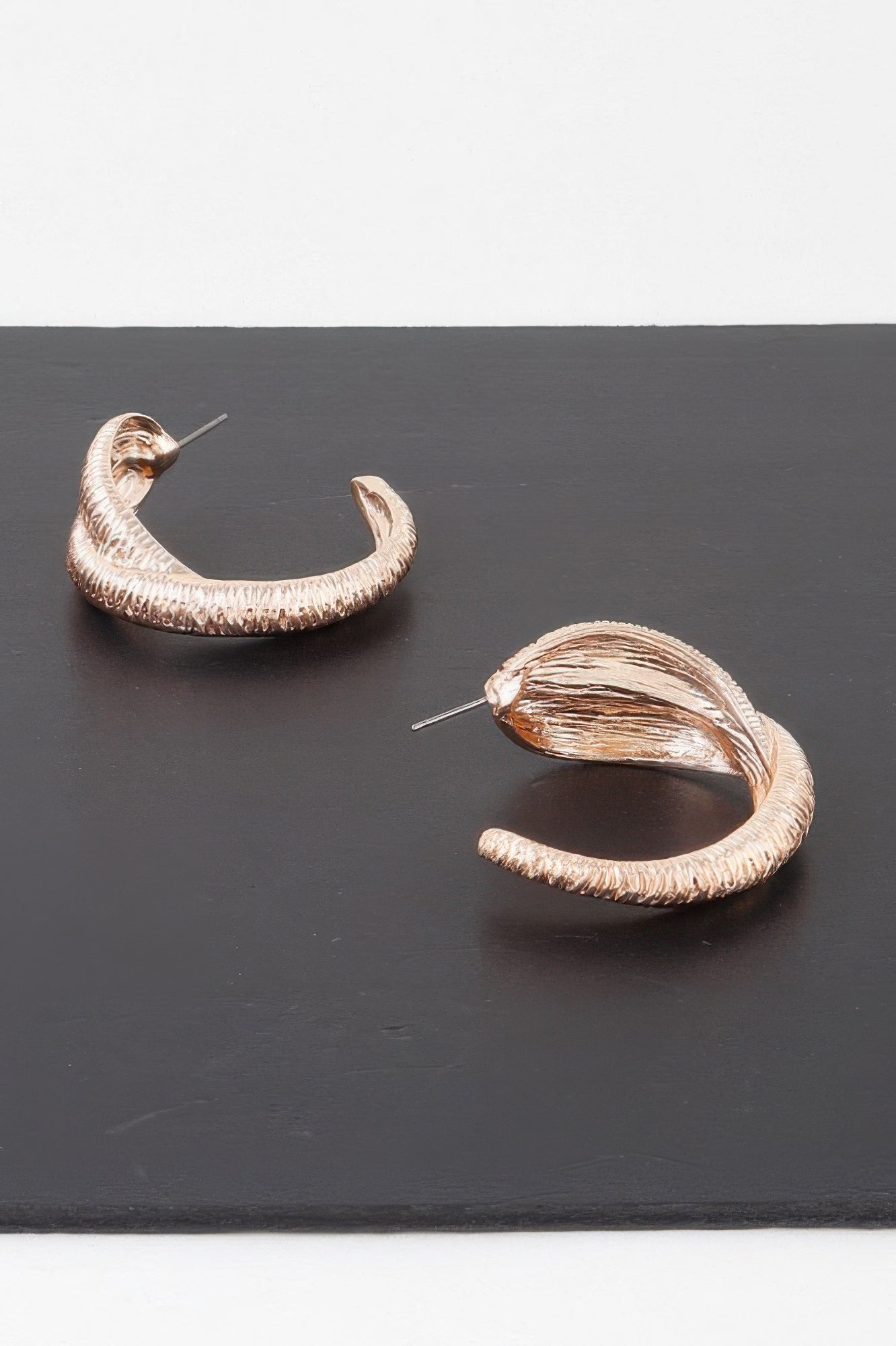Ribbed intertwined hoop earrings, gold-tone hoops with layered ridged texture