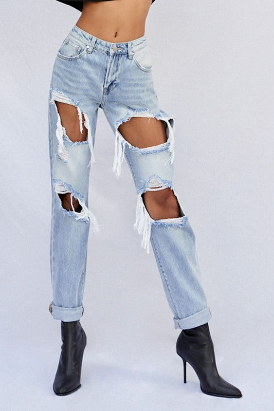 Light ripped baggy jeans with large knee and thigh cutouts, frayed hems