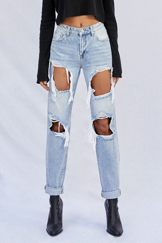 Light ripped baggy jeans with oversized thigh and knee rips, frayed edges