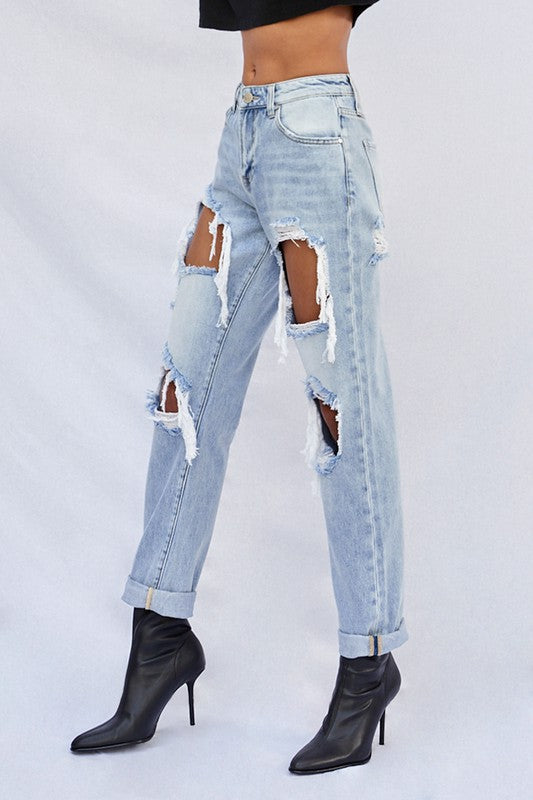Light baggy jeans side view with multiple ripped panels and frayed ankle cuffs