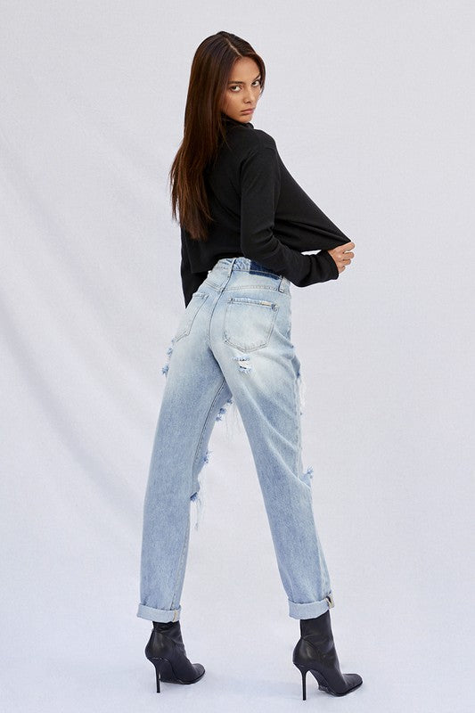 Light baggy jeans side view with back pockets and knee distressed rips
