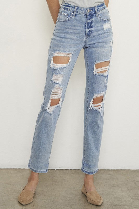 Light wash boyfriend jeans with side thigh and knee rips, frayed edges