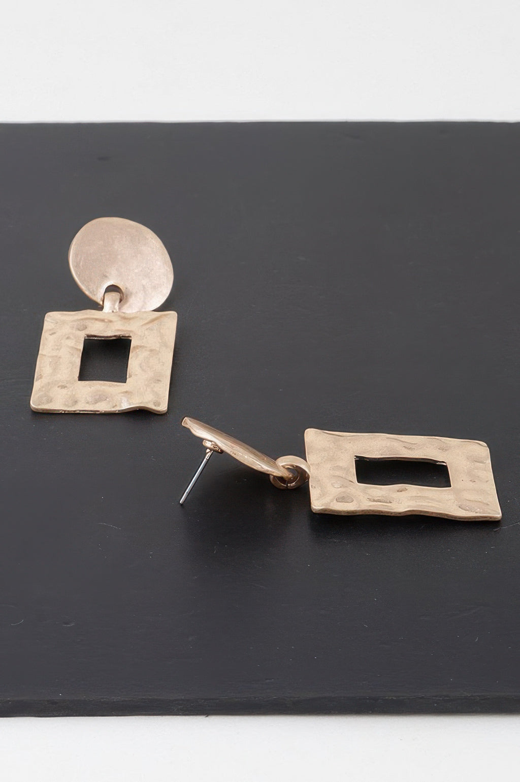 Gold-tone earrings showing back posts and square ripple frames