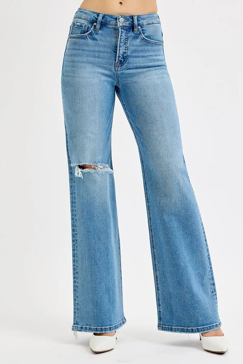 Medium-wash jeans with knee distress and wide-leg fit, button fly