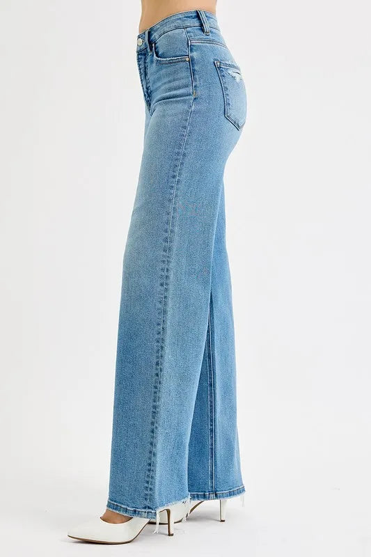 Side view medium-wash wide-leg jeans with frayed hem and subtle distress