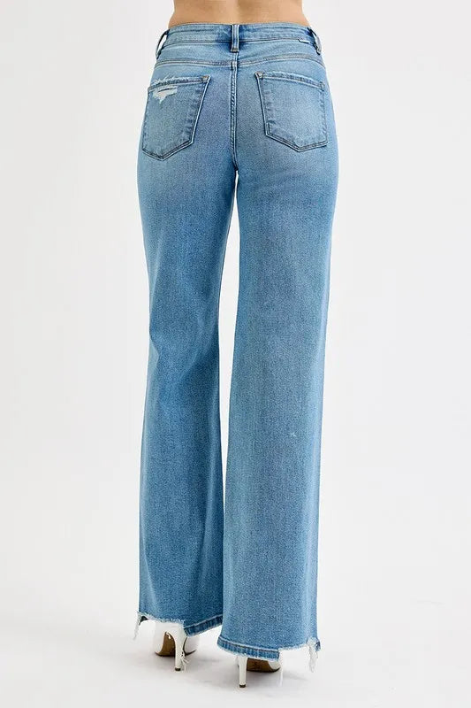 Back view medium-wash wide-leg jeans with back pockets and frayed hems