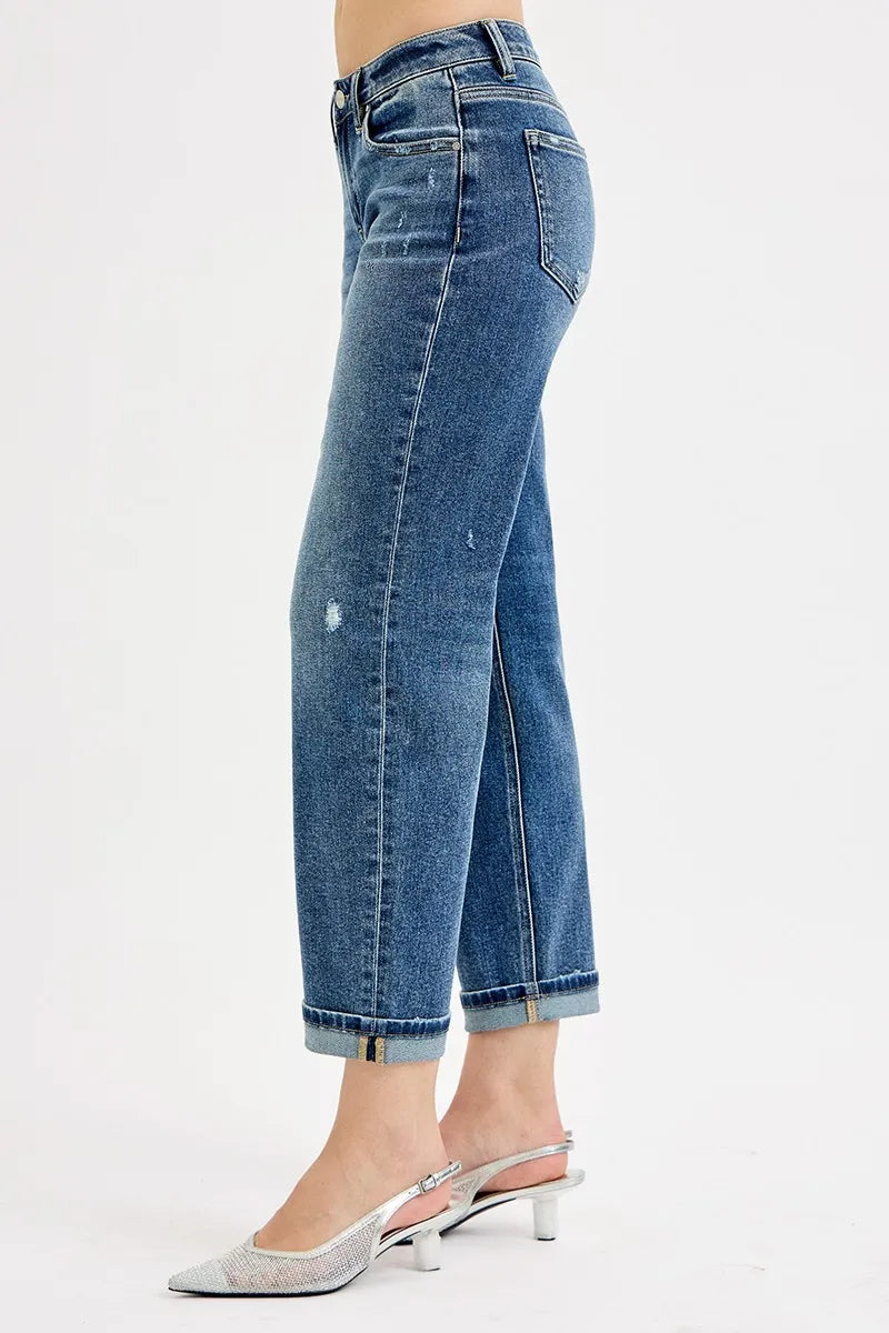 Side view of low-rise boyfriend crop jeans, dark blue wash, stitched seams and cuff