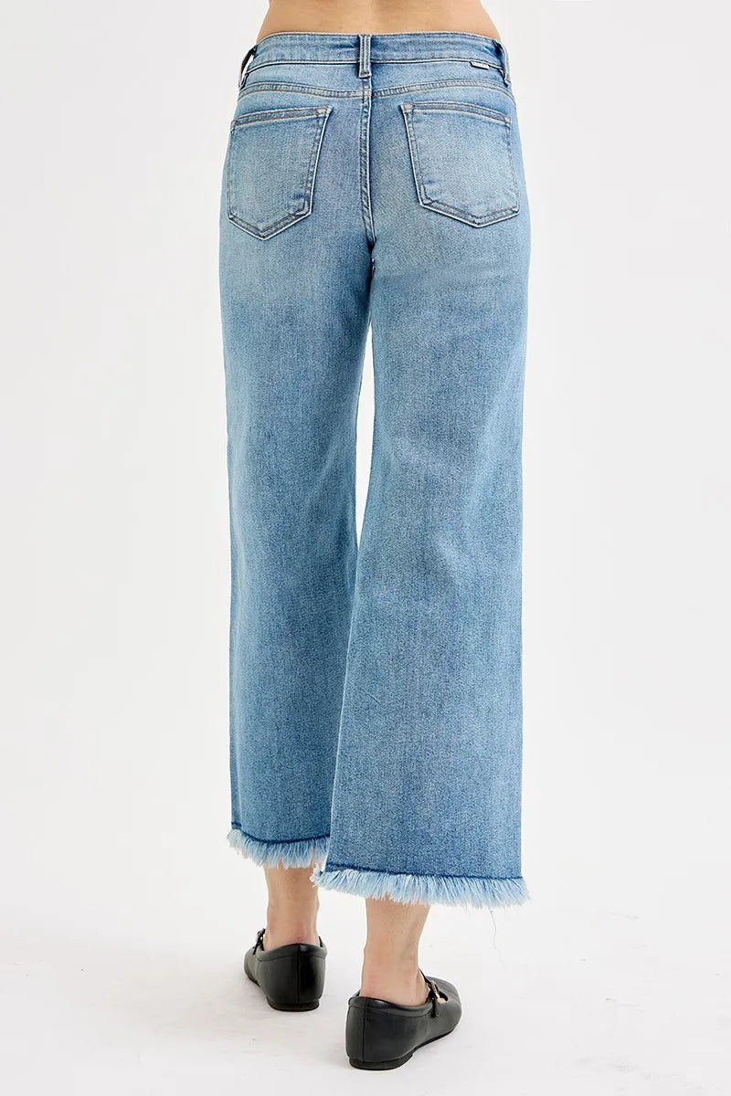 Light-wash jeans with back pockets and frayed cropped hems, wide-leg fit
