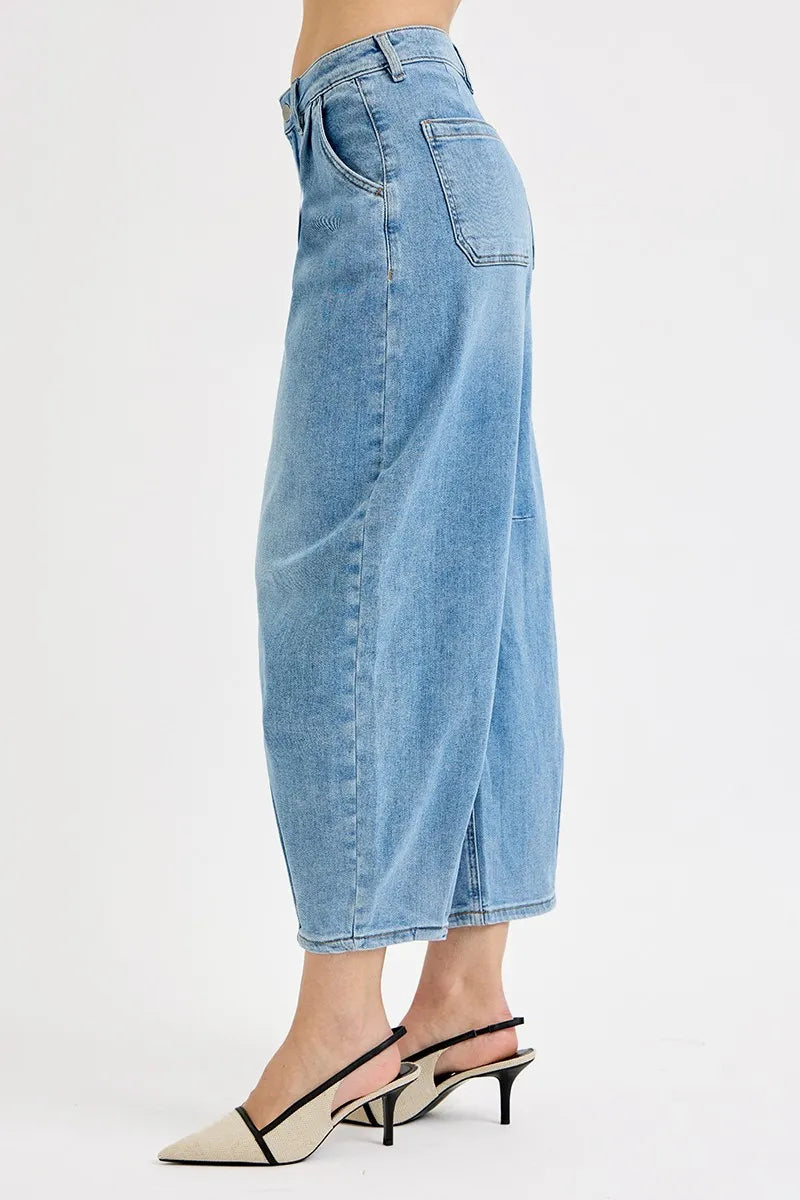 Side view of medium-wash mid-rise crop wide-leg jeans with back welt pocket