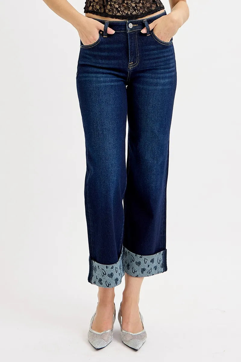 Dark blue wide-leg cropped jeans showing mid rise waistband and printed cuff