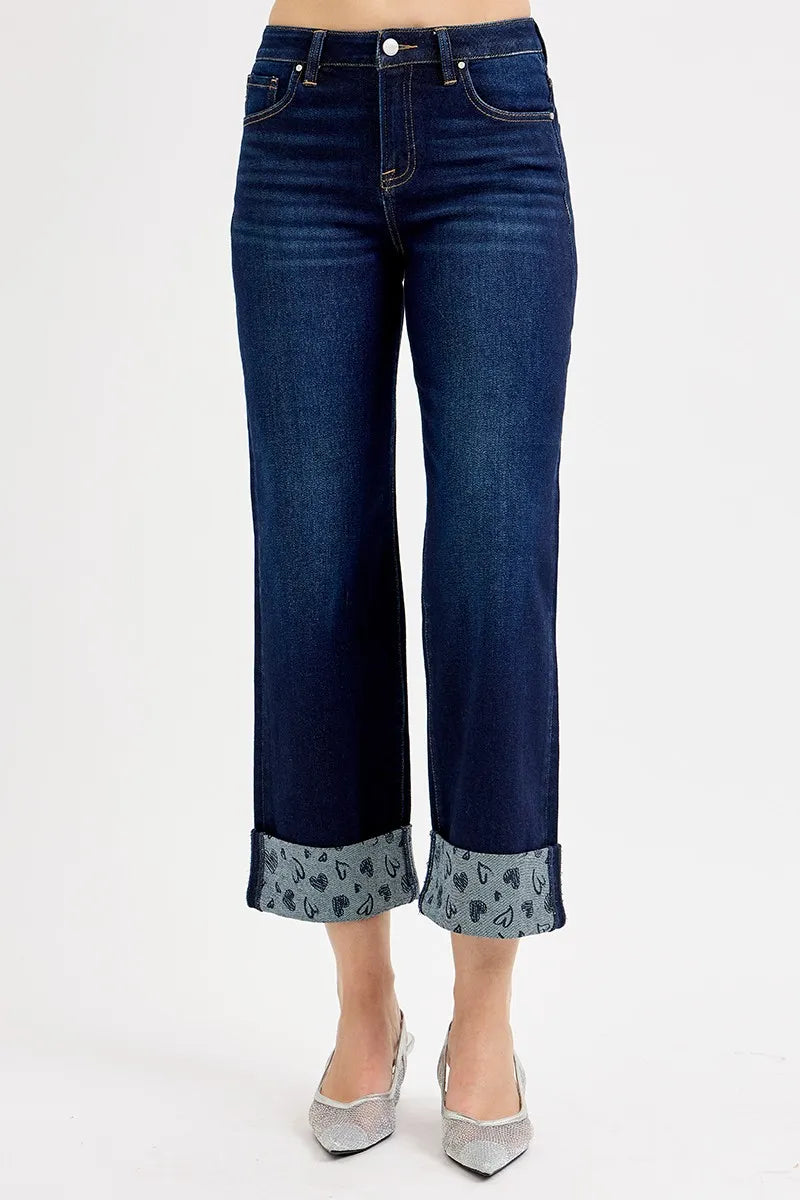 Back view of dark blue mid-rise wide-leg cropped jeans with printed cuff hems