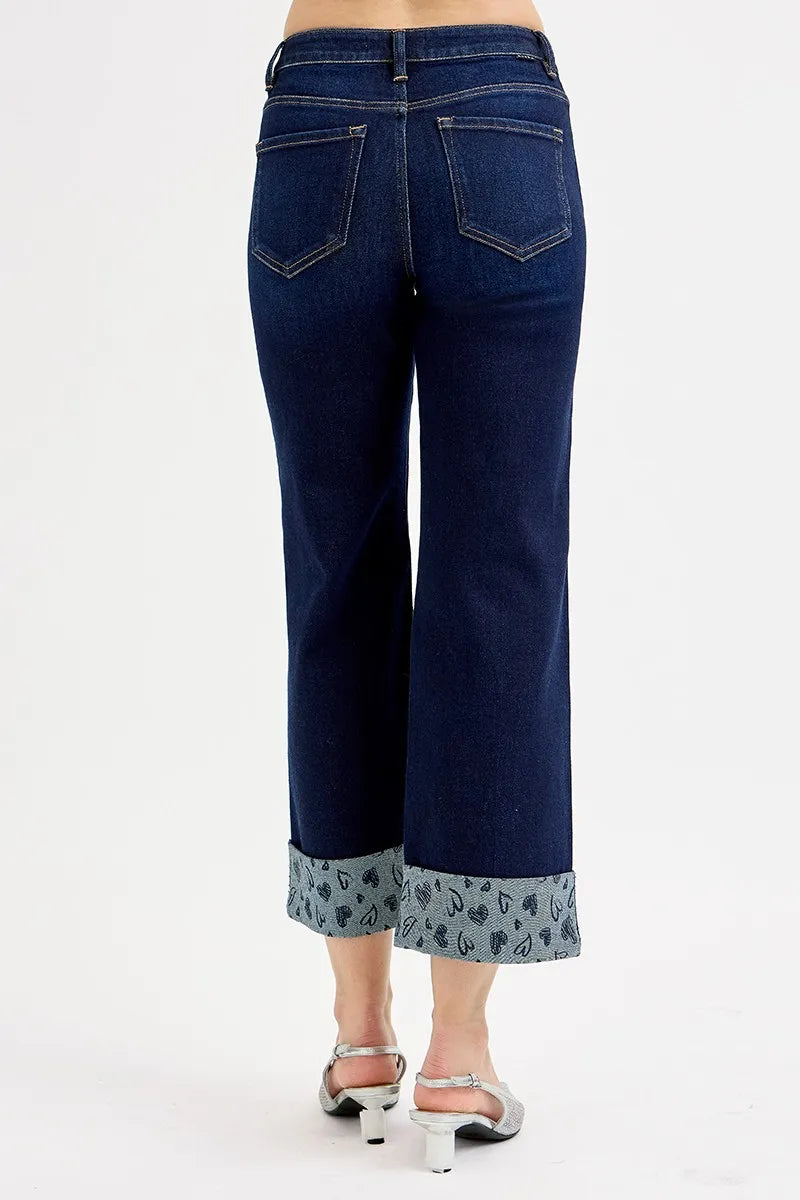 Dark blue jeans back with belt loops, pockets, and printed cuff at hem