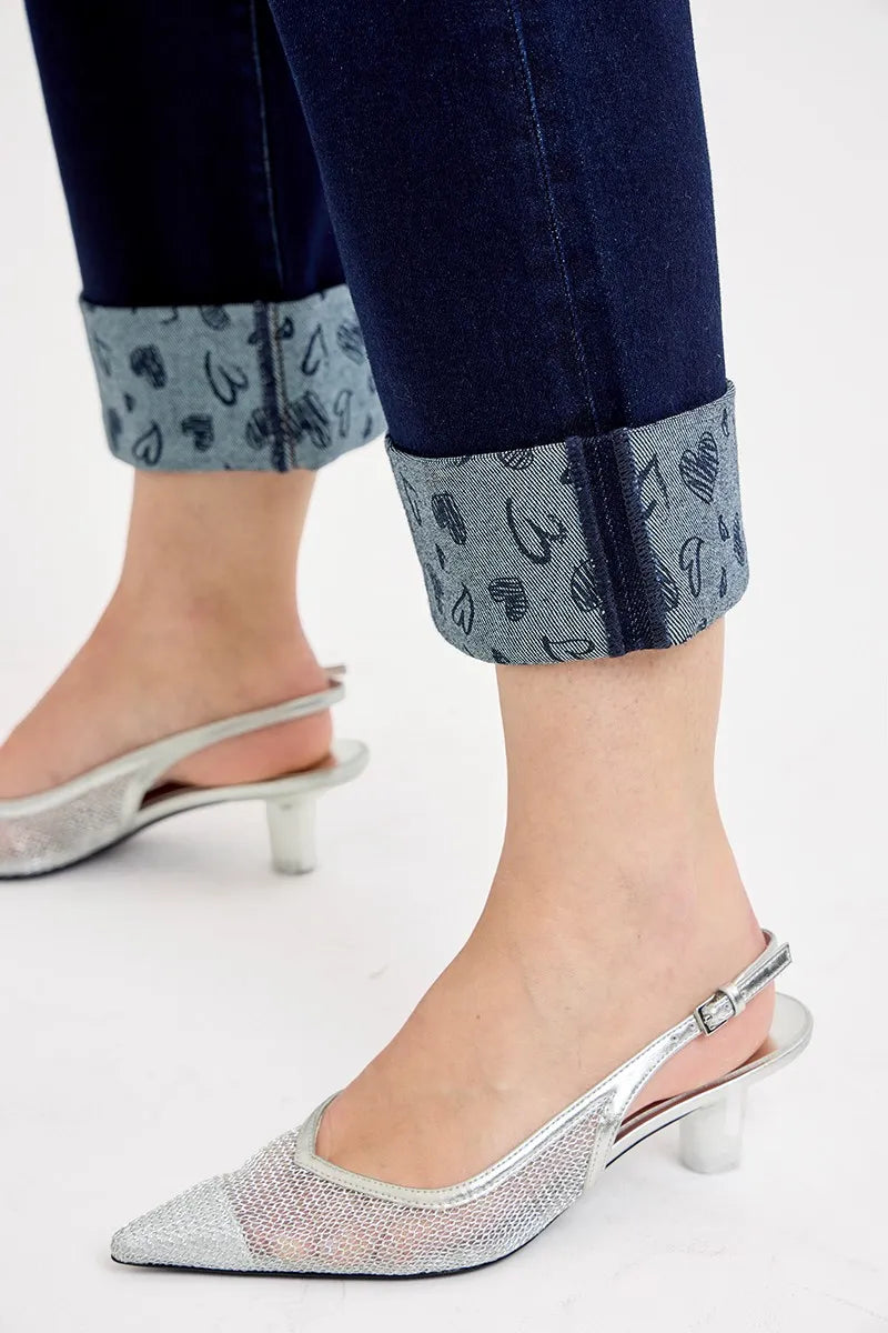 Close-up of dark jeans hem with printed cuff and wide-leg cropped fit
