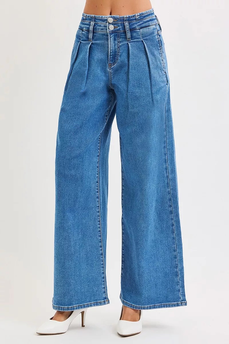 Front view medium wash wide-leg denim jeans with pleated waist and button closure