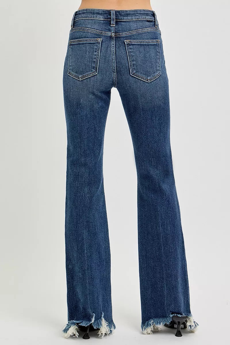 Dark wash jeans back view with two patch pockets and frayed flared hem.