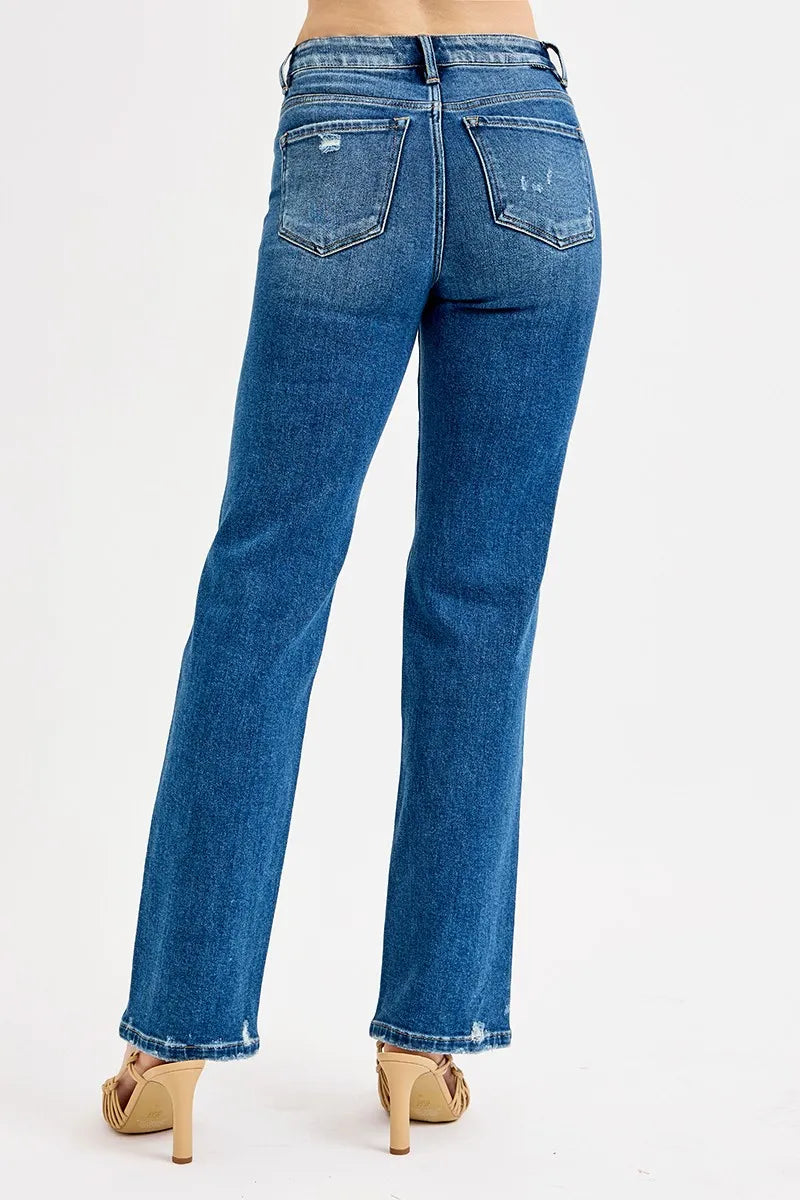 Dark blue high-rise straight jeans, back pockets and slight distress along the legs