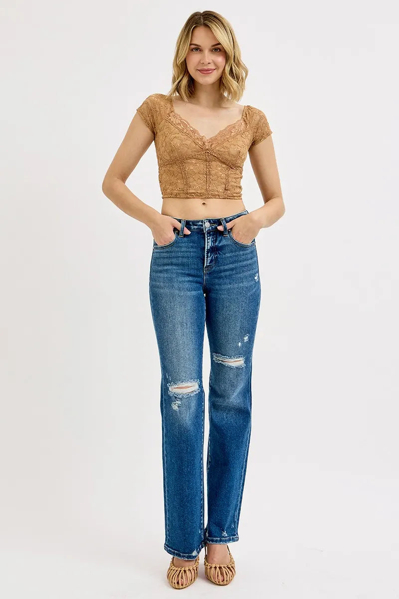 Full-length dark blue high-rise straight jeans, ripped front panels and frayed cuffs