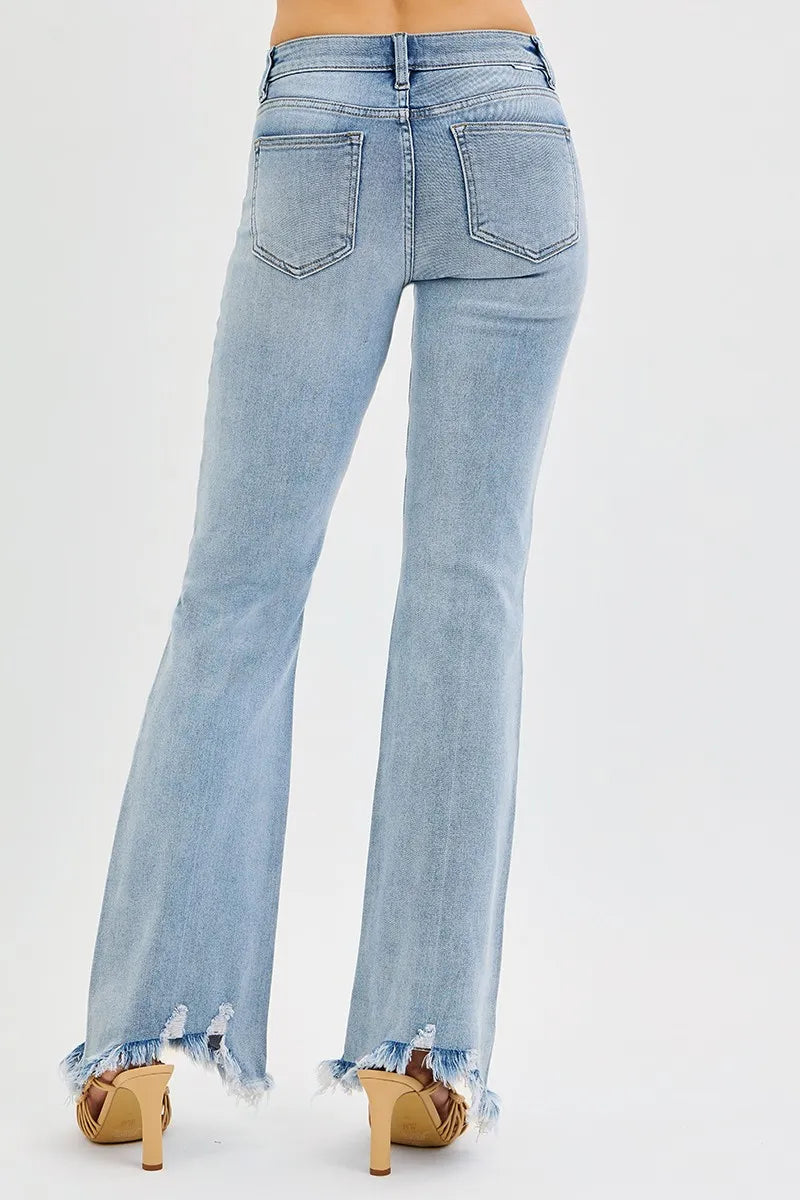 Back pockets and waistband of medium wash mid-rise flare jeans with frayed hem