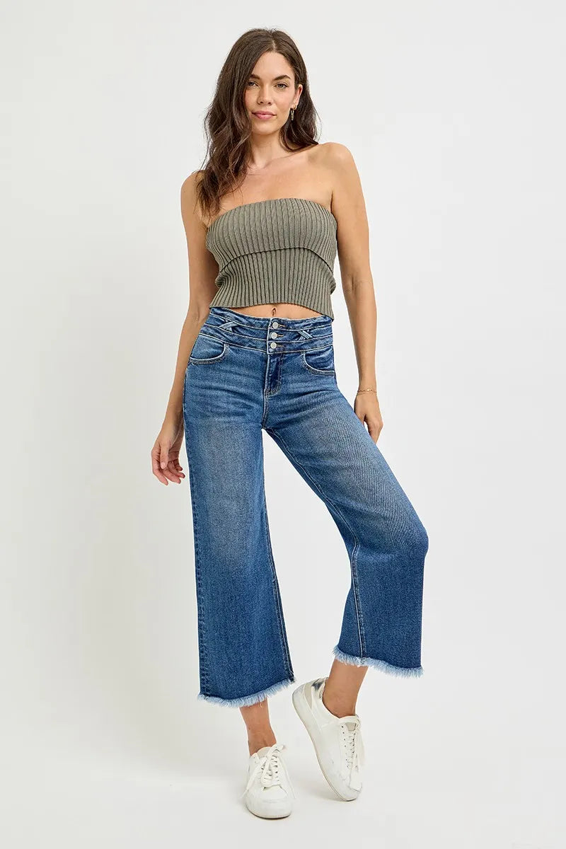 Model wearing dark high-rise crop wide-leg jeans with button front and frayed cuffs