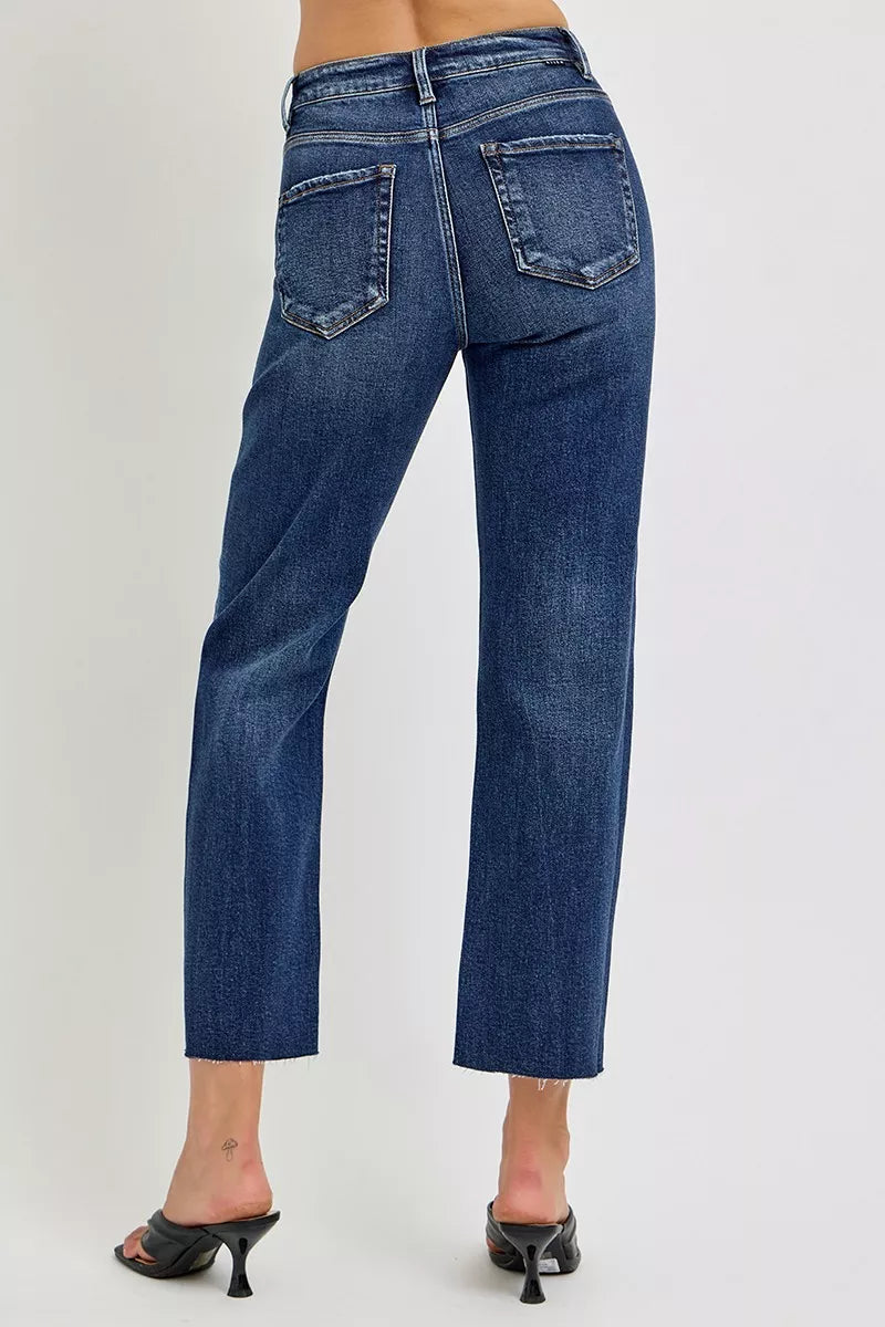 High-rise slim barrel jeans, dark blue wash, front patch pockets and visible seams