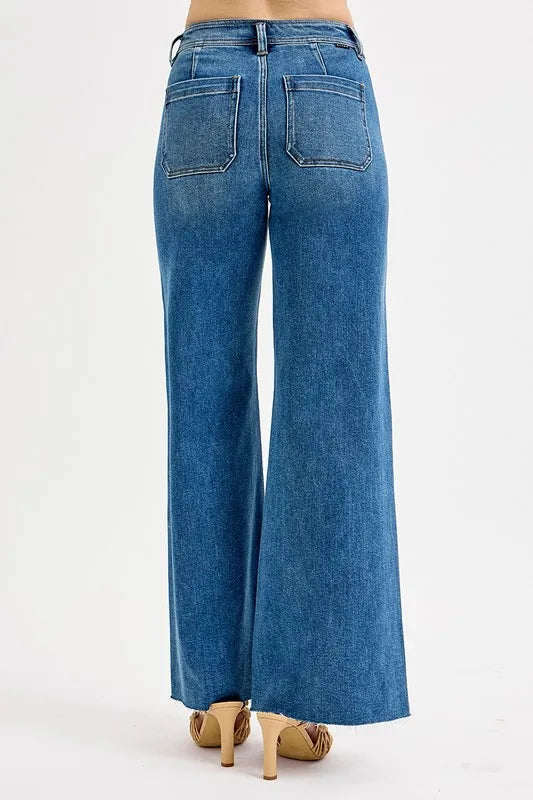 Rear view of medium-wash high-waisted wide-leg jeans with two patch back pockets