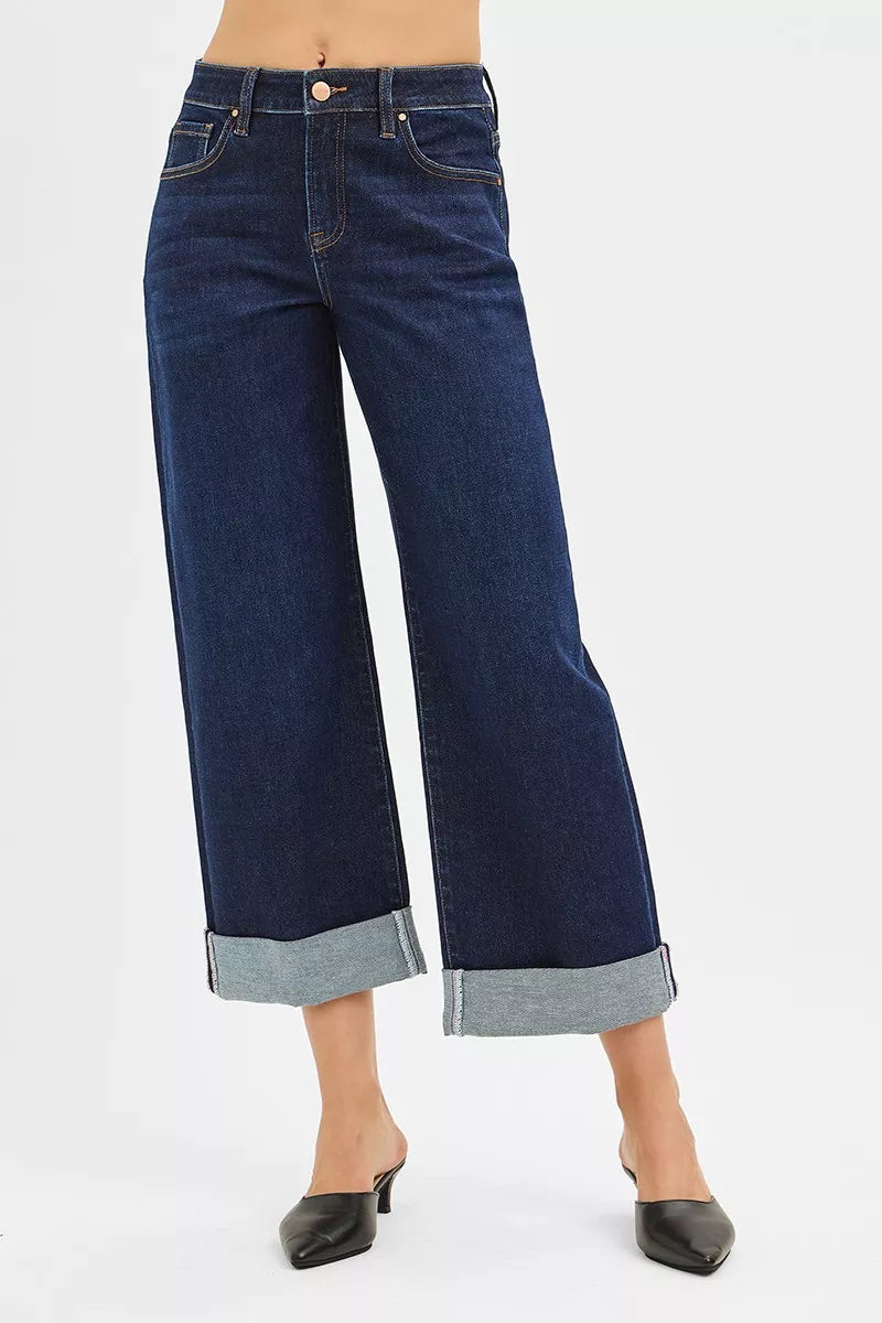 Dark mid-rise wide-leg jeans, rolled cuffs at ankle