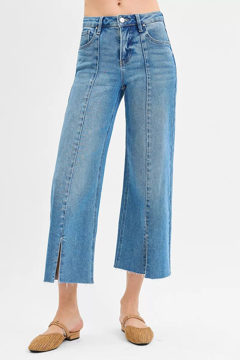 Medium wash wide-leg jeans with front slits, mid-rise cropped length