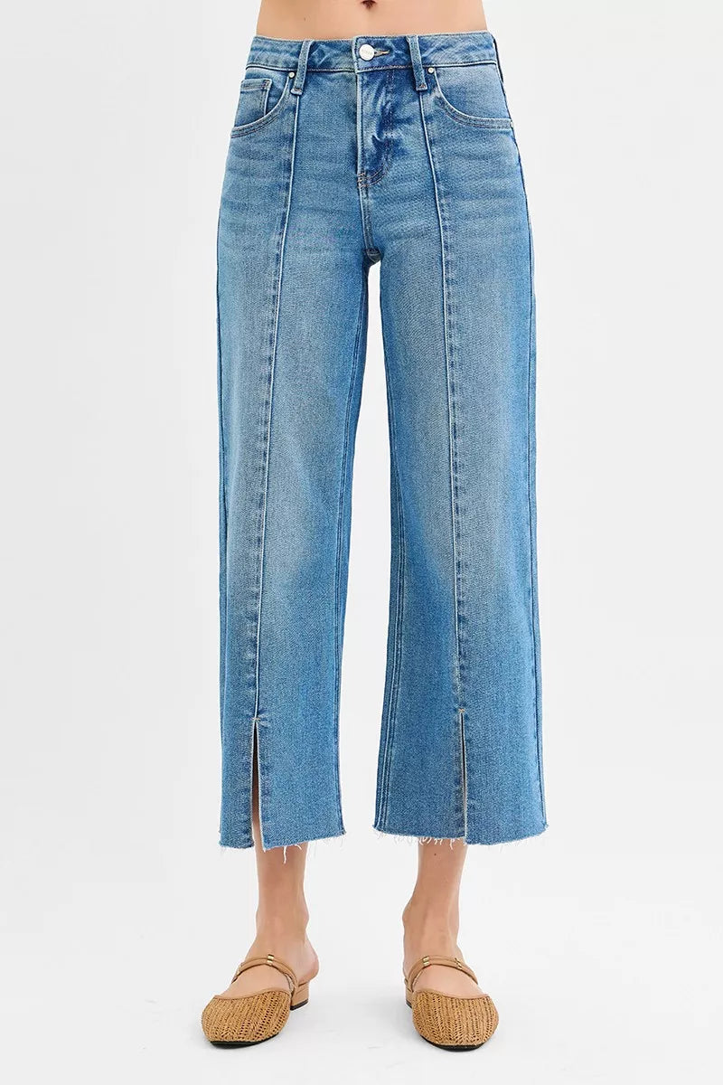 Medium wash mid-rise wide-leg jeans with front slits and cropped hems