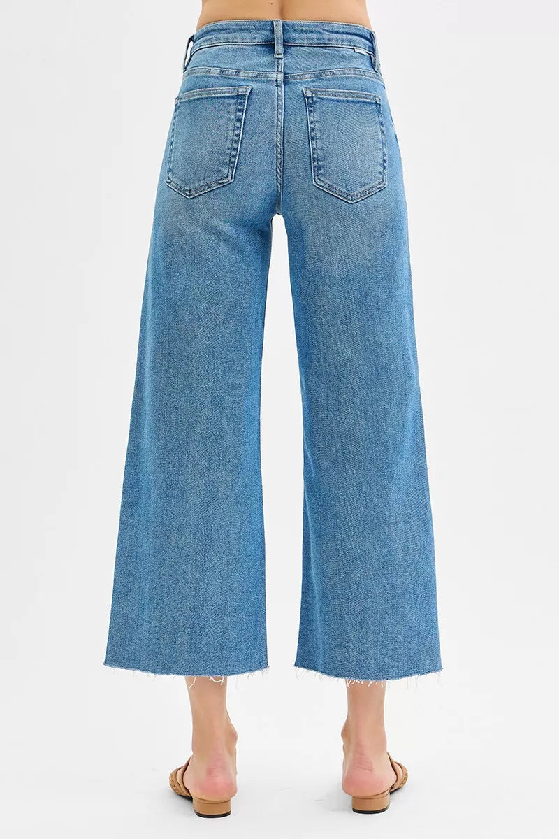 Back view of medium wash mid-rise wide-leg jeans with two rear pockets