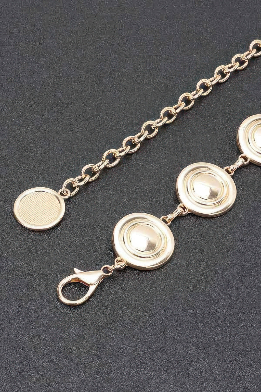 Gold round disc charm chain belt close-up with layered circular medallions