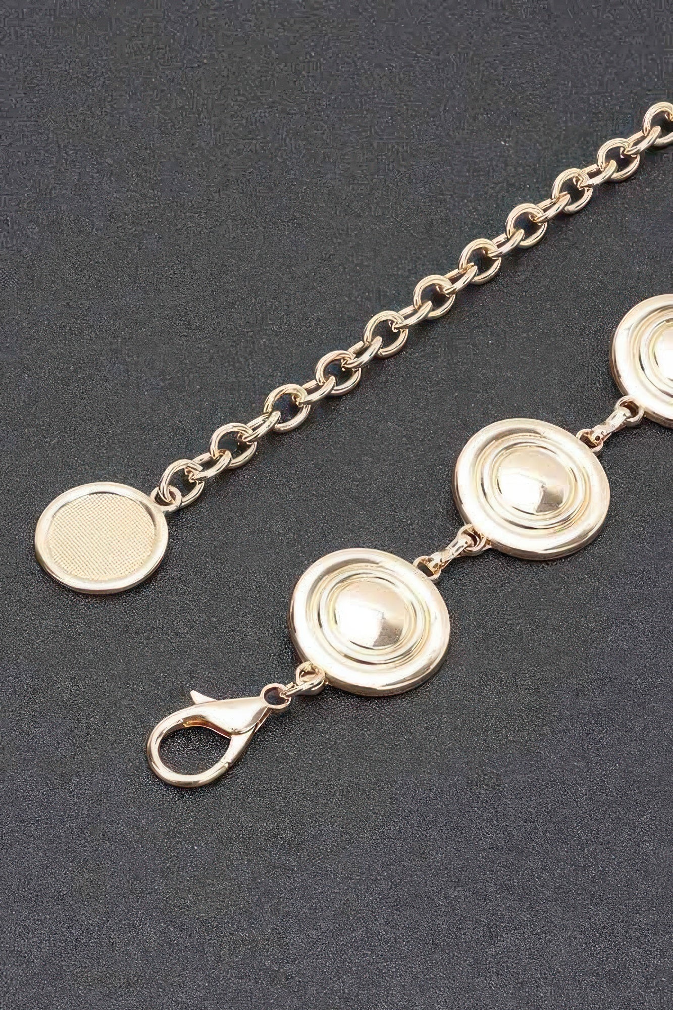Gold round disc charm chain belt close-up with layered circular medallions