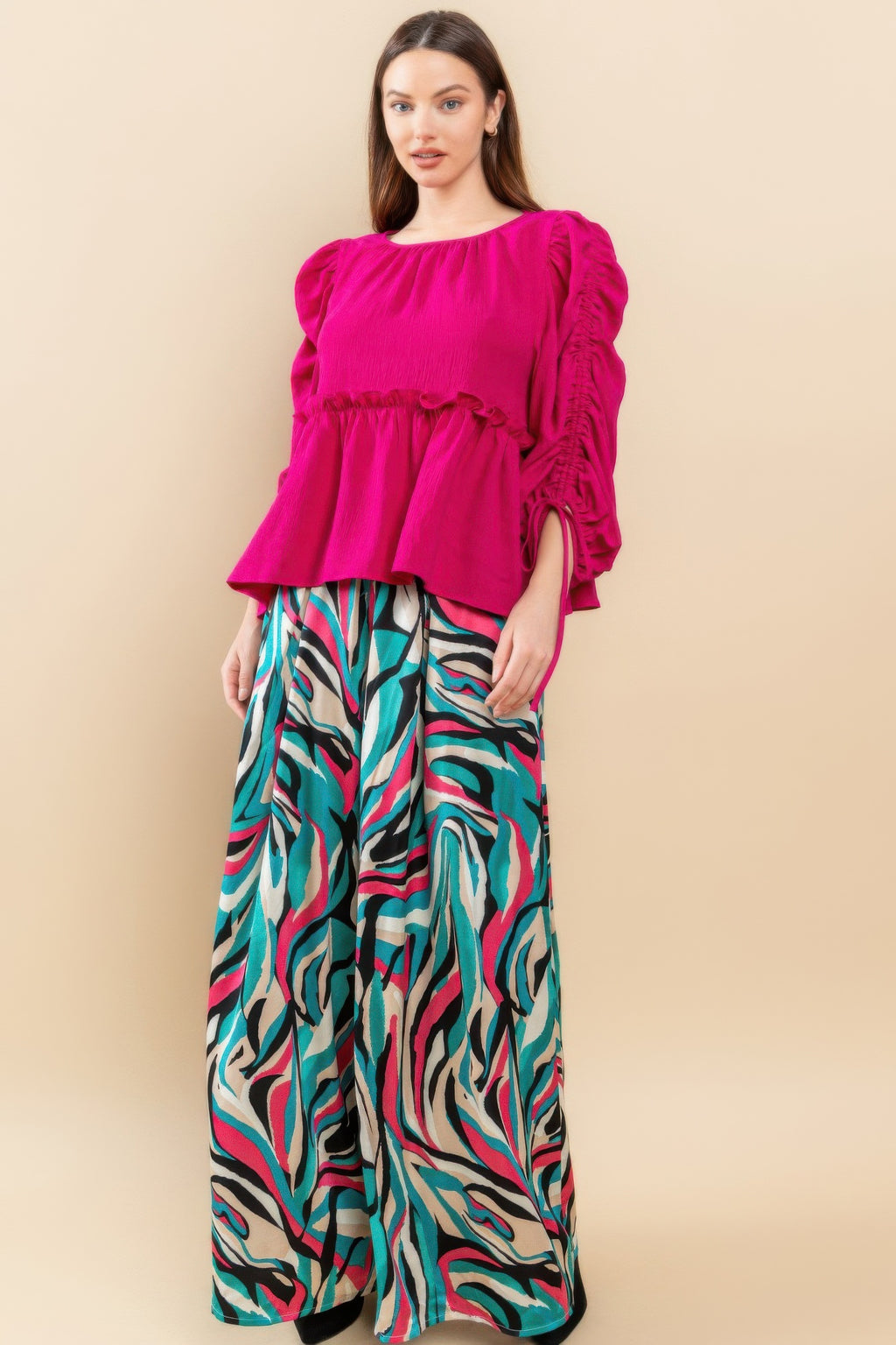 Magenta babydoll top with gathered round neckline, tiered hem, and drawstring tie sleeves