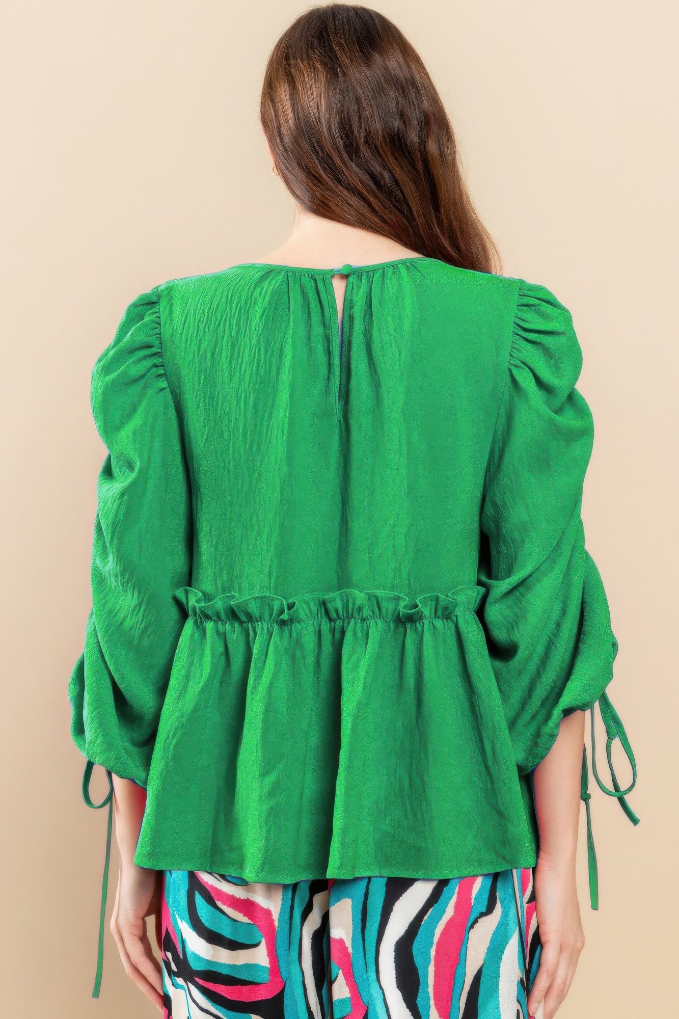 Kelly green babydoll top back view with gathered waist and ruched puff sleeves