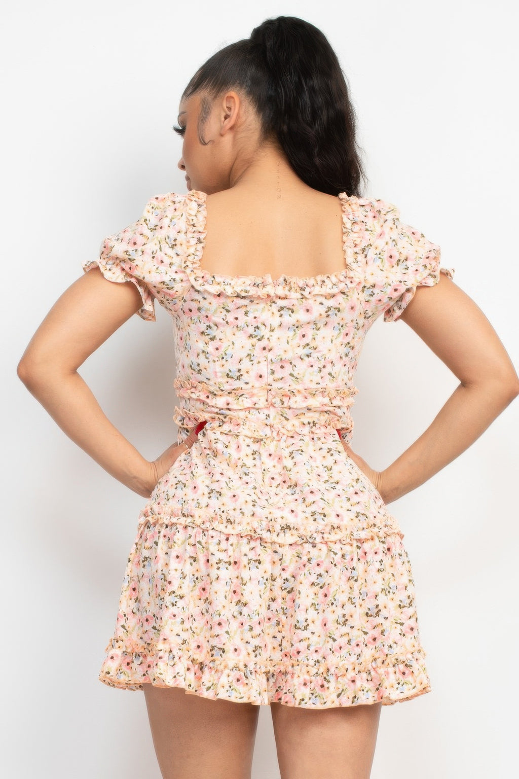 Pink floral puff sleeve dress from back, gathered waist and tiered skirt