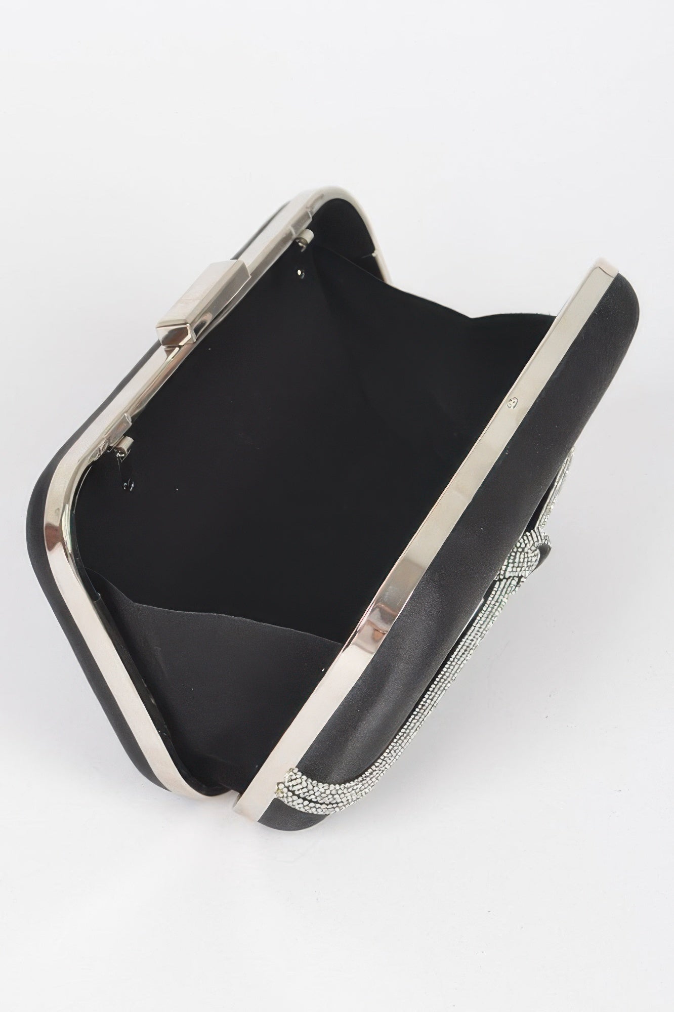 Black satin frame party clutch open view with metal frame and rhinestone chain handle