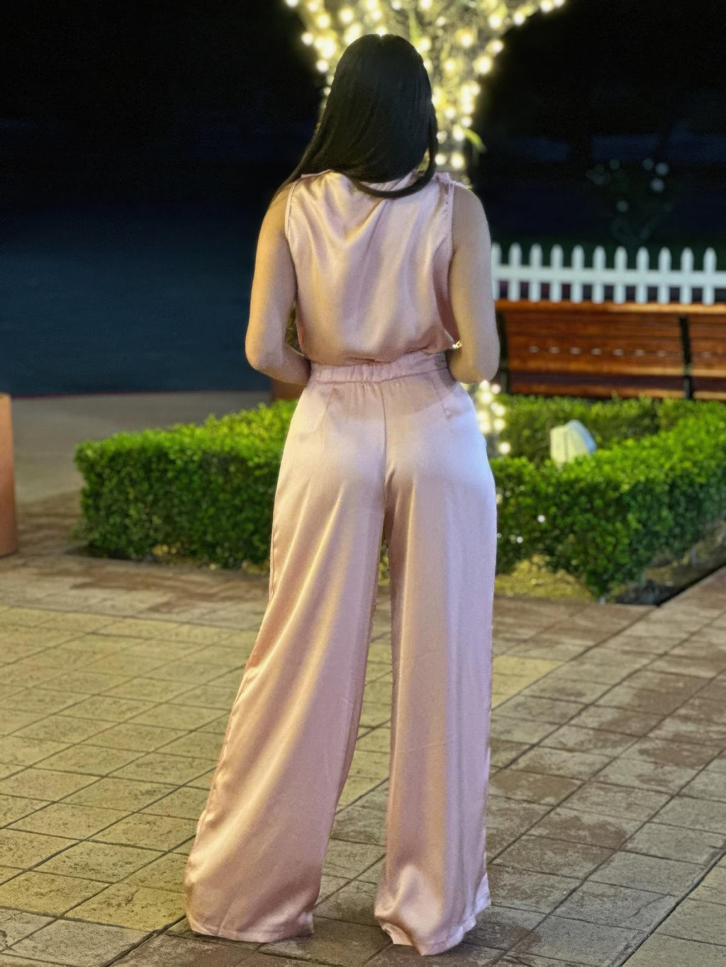 Light pink satin back view: sleeveless top and wide-leg pants with flowing drape