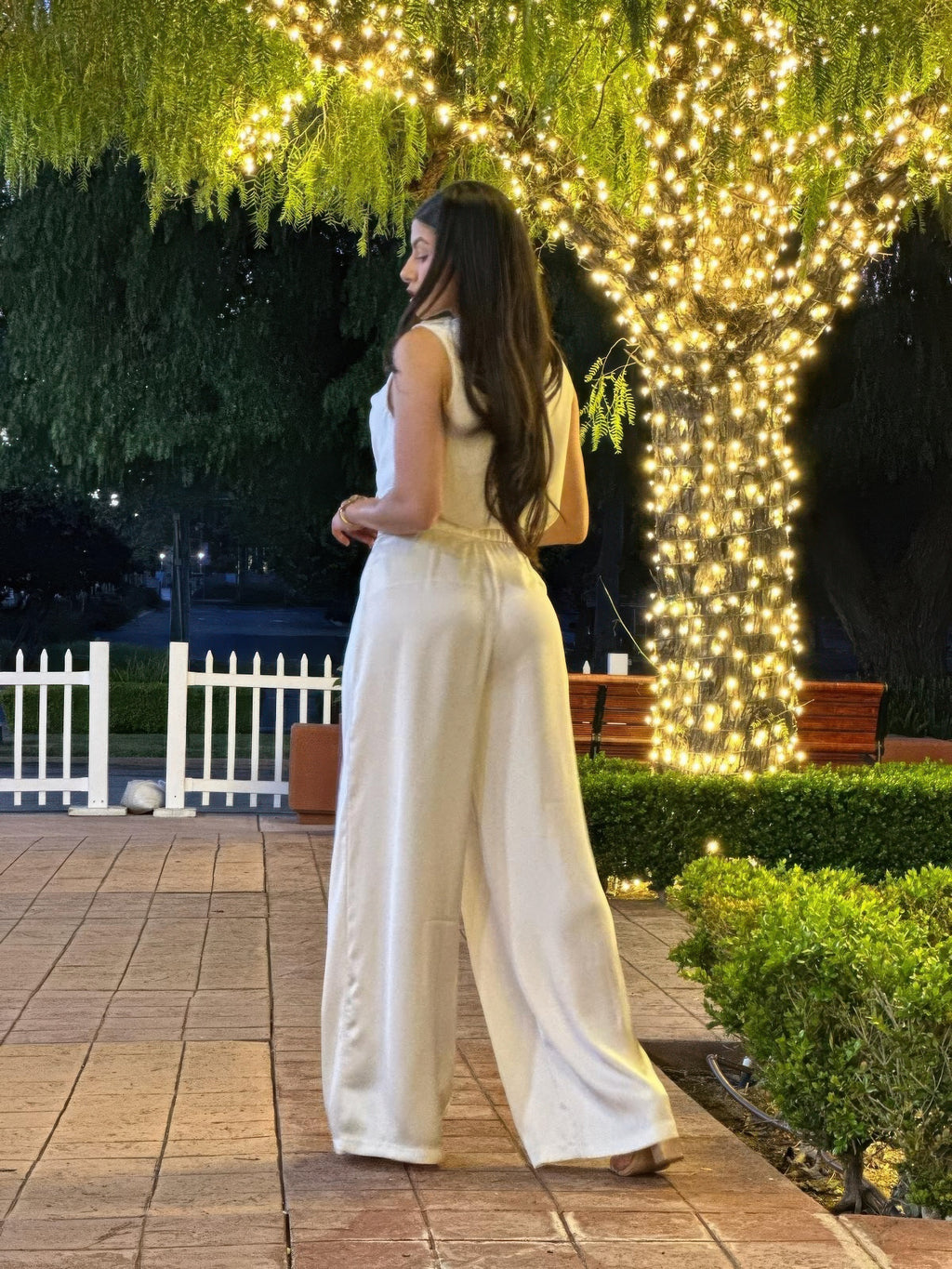 Light cream satin sleeveless top and flowy wide-leg pants, back/side view