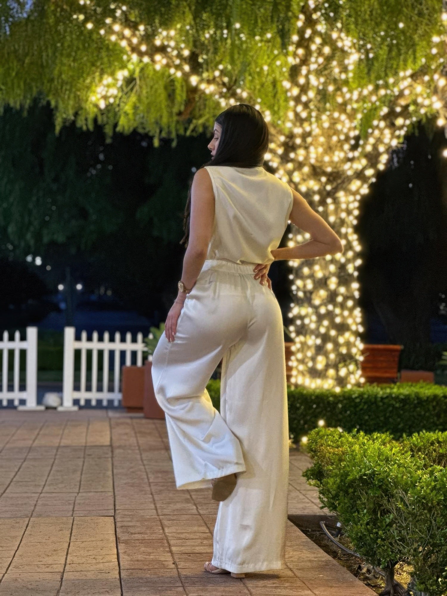Back view of light cream satin wide-leg pants and sleeveless top with gathered waist