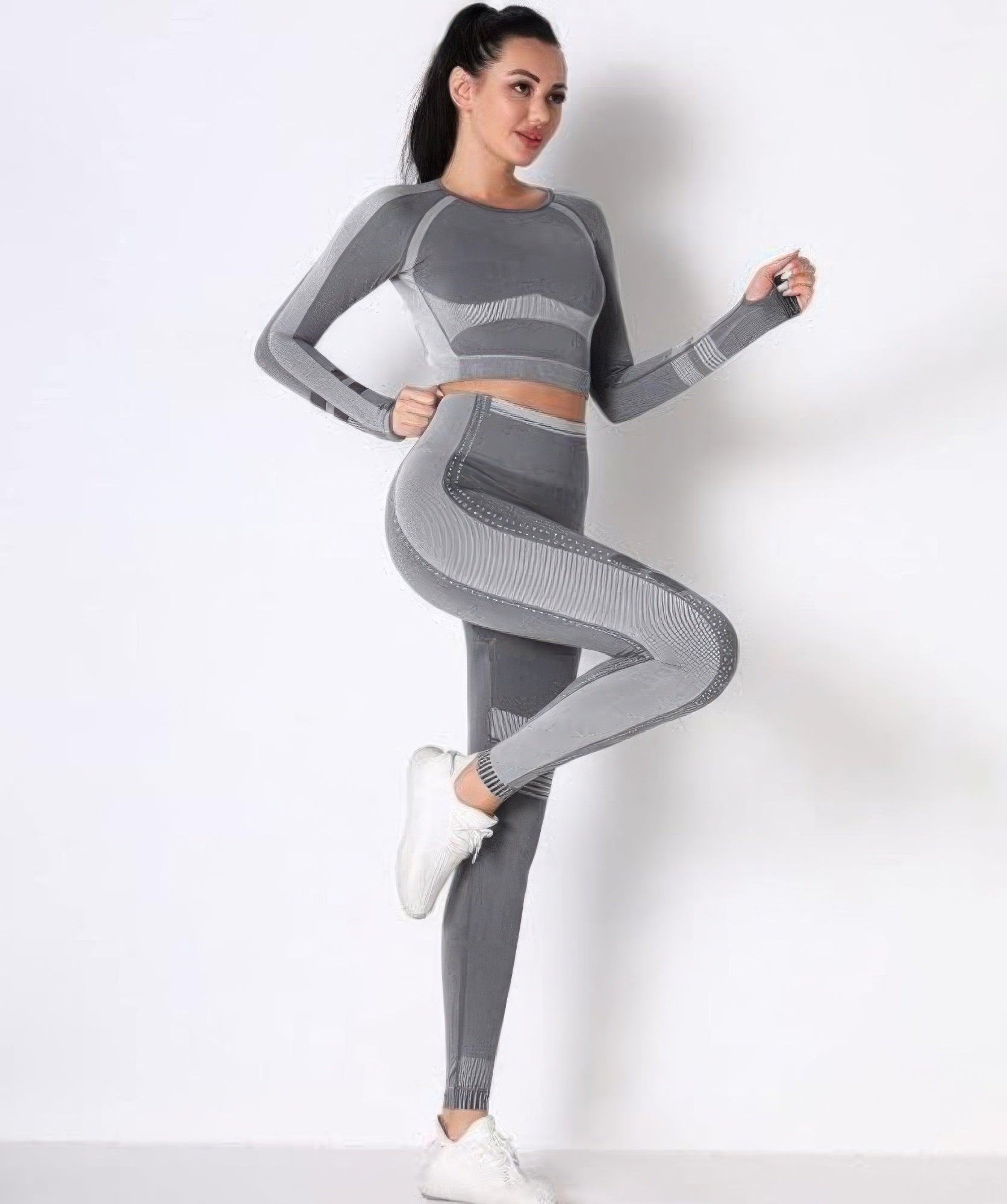 Seamless yoga set in grey: long-sleeve crop top with matching high-waist leggings.