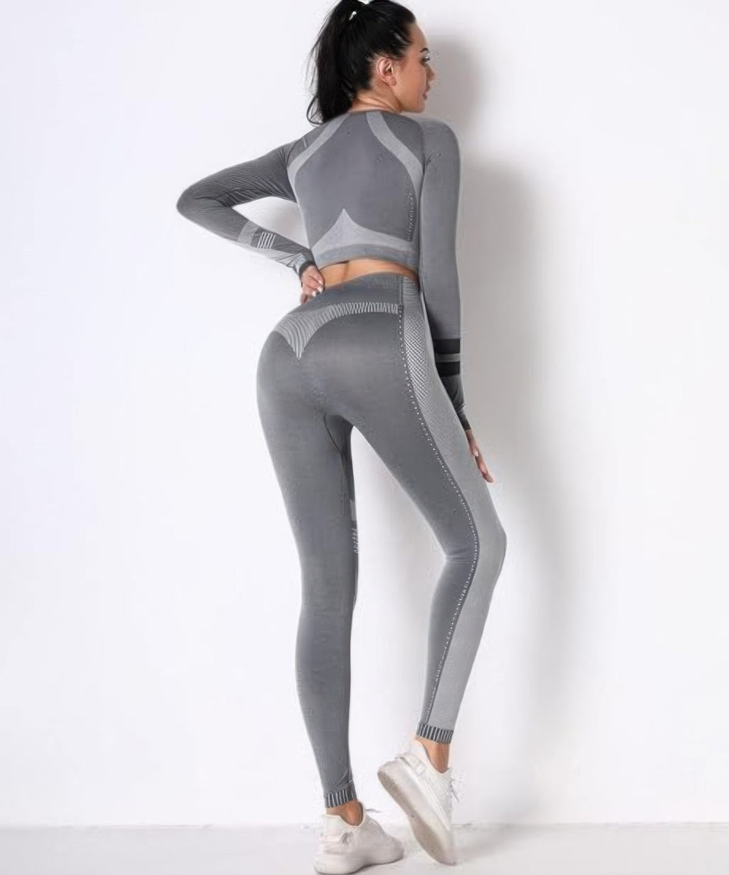 Seamless set back view, grey long-sleeve crop and leggings with striped center panel.